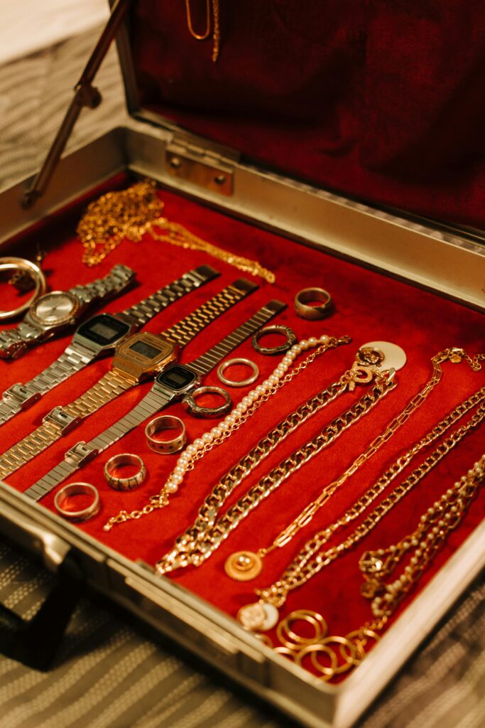 pexels-photo-8705773-8705773 A stylish open case showcasing a luxurious collection of watches, rings, and chains.